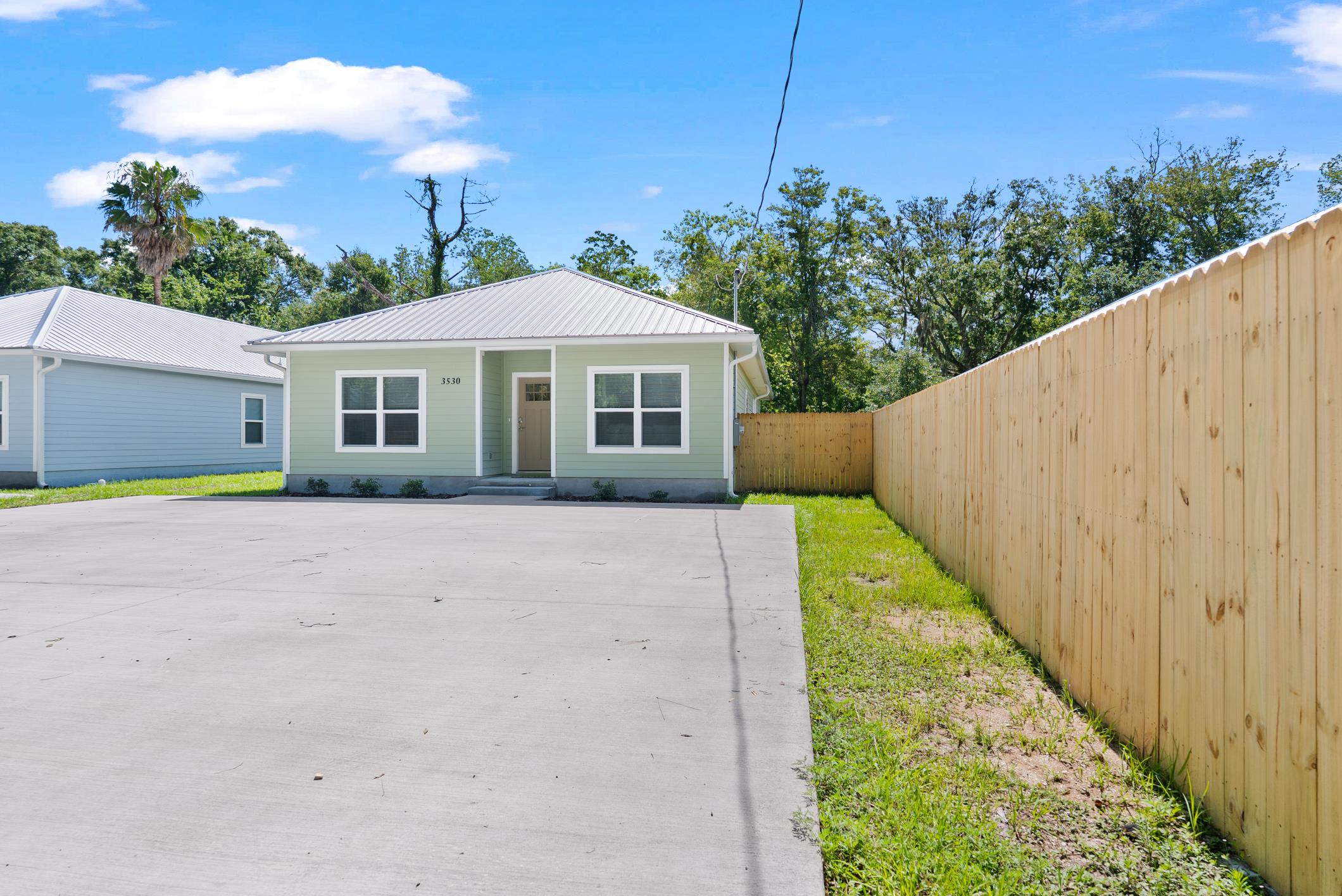 Front yard and fenced grounds at 3540 Datura Street