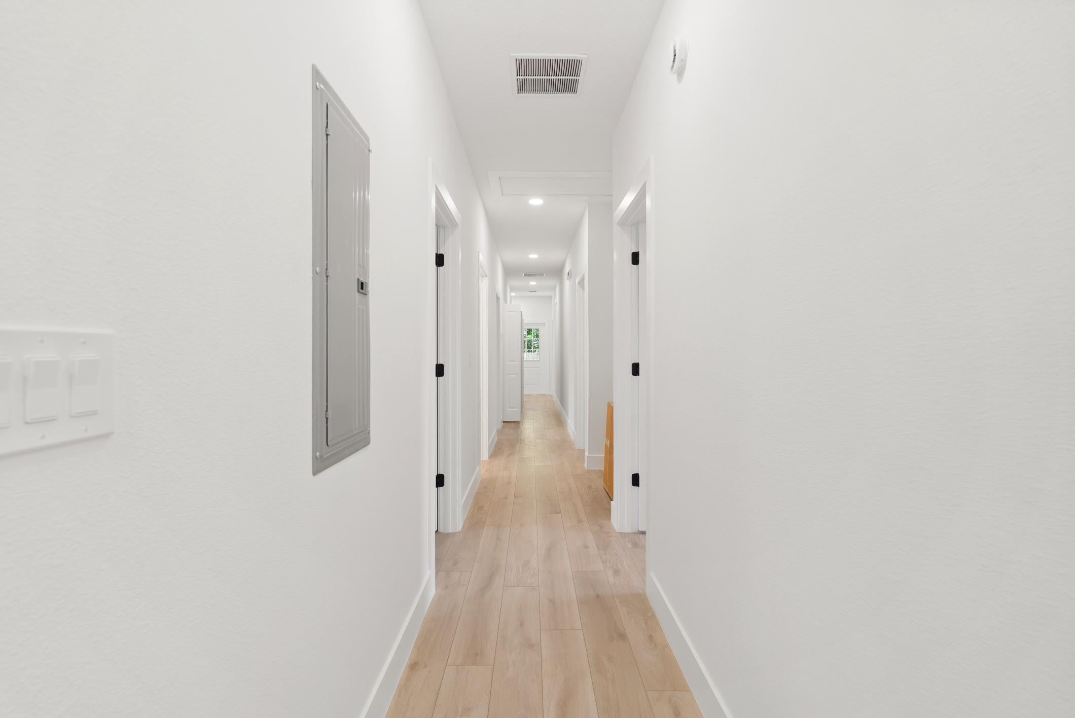 Wide accessible hallway connecting resident rooms