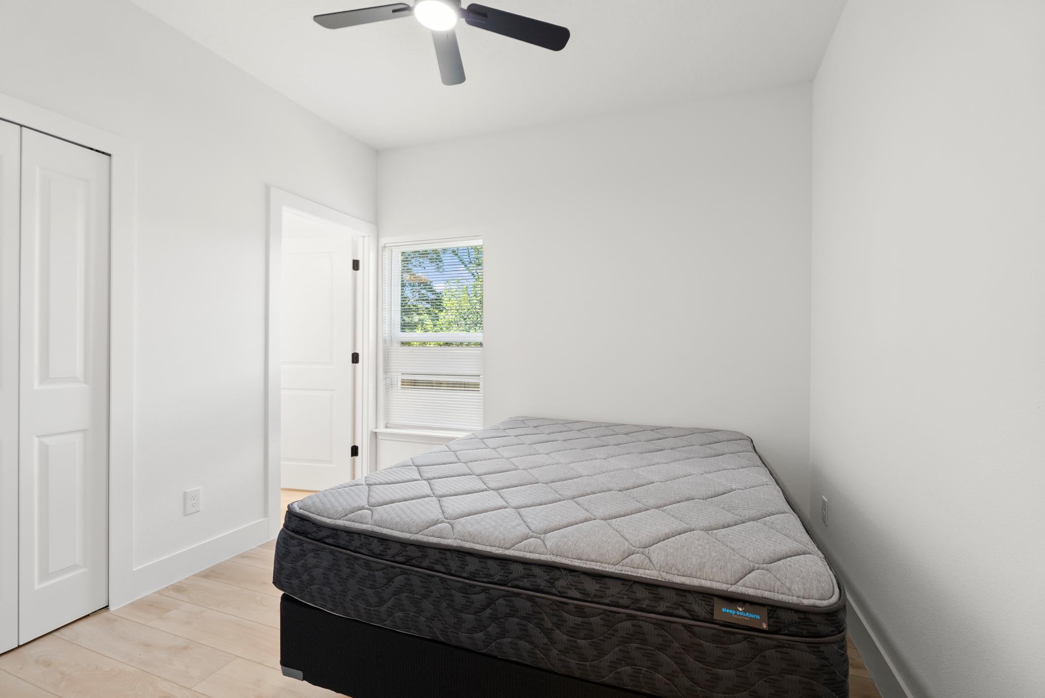 Bright private bedroom with ceiling fan