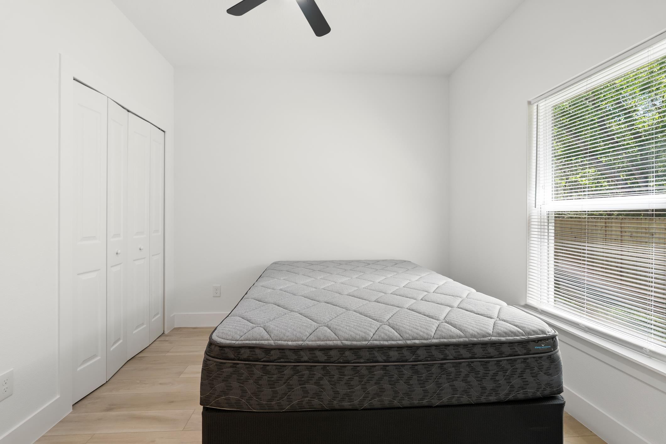 Private bedroom with double closets and ceiling fan