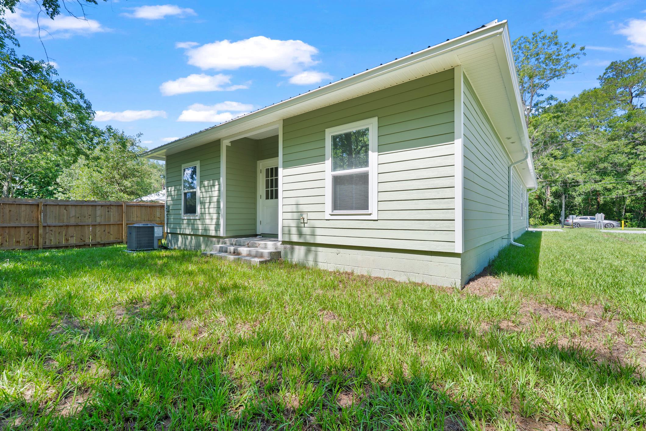 Rear exterior of the home with green space